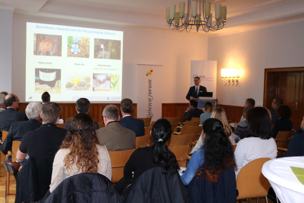 Vortrag über Biopolymere für die Verpackungsindustrie vor Publikum in einem Konferenzraum